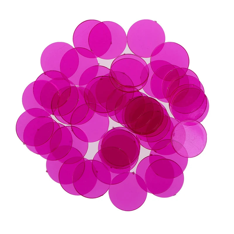 A pile of 50 magenta plastic bingo chips for games and family fun