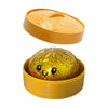 A set of yellow squishy toys, including a lid and a glittery ball.