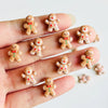 A hand displays a set of 30 gingerbread resin nail art charms for DIY decoration.