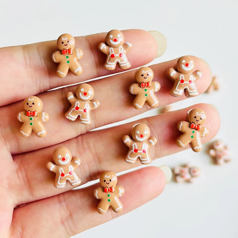 A hand displays a set of 30 gingerbread resin nail art charms for DIY decoration.