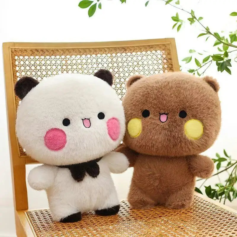 A pair of soft, cute panda plush toys, Bubu and Dudu, sitting on a woven surface.
