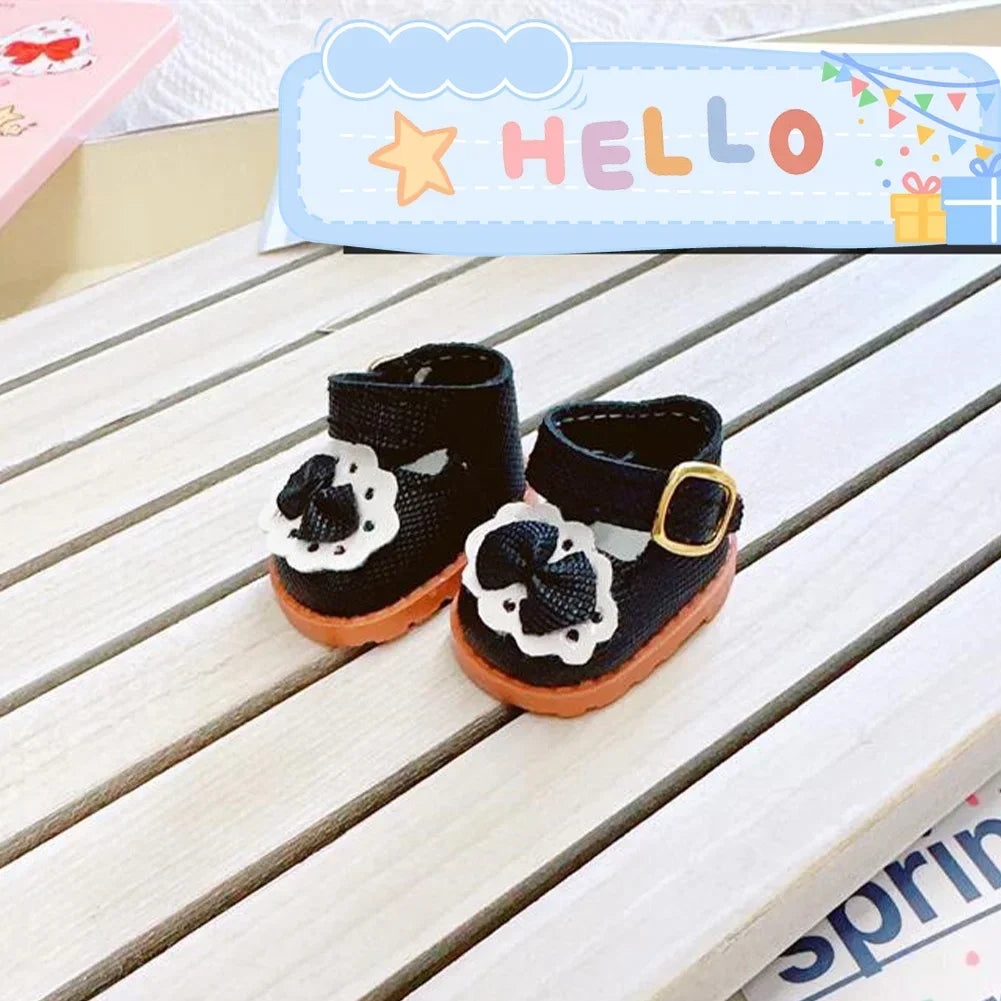 A pair of black casual sneakers with white floral patterns for 17cm Labubu dolls