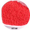 A pile of bright red 1.5mm solid glass seed beads for jewelry and craft.