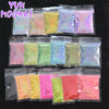 Assortment of holographic rainbow nail glitter in various shades packaged in small plastic bags