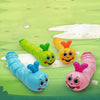 A set of colorful wind-up caterpillar crawling toys in green, yellow, blue, and pink against a light green background.