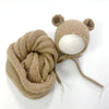 A knitted bear hat and wrap set in a light beige color for newborn photography.
