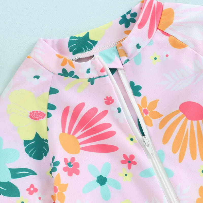 Pink baby rash guard swimsuit with a floral print and a zipper detail