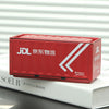 A red DHL shipping box with white text and arrows resting on a white book.