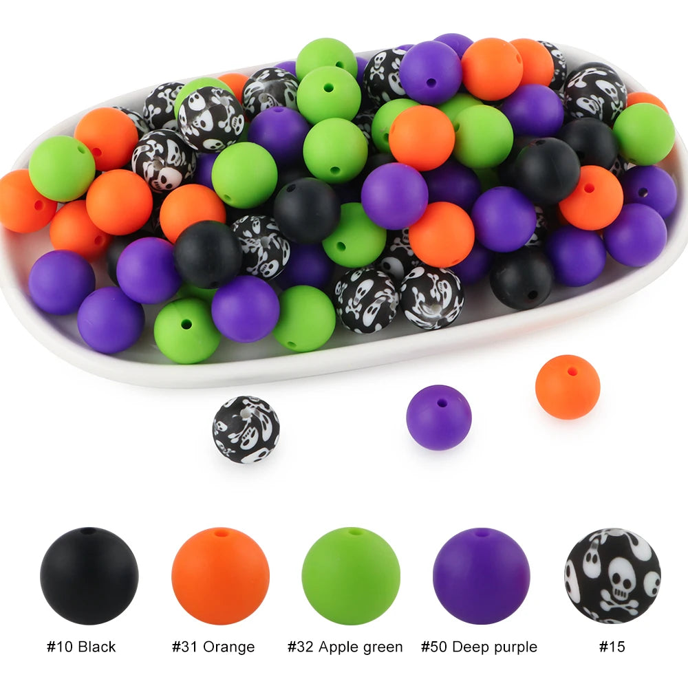 A variety of colorful silicone beads in black, orange, green, and purple are displayed in a white dish.