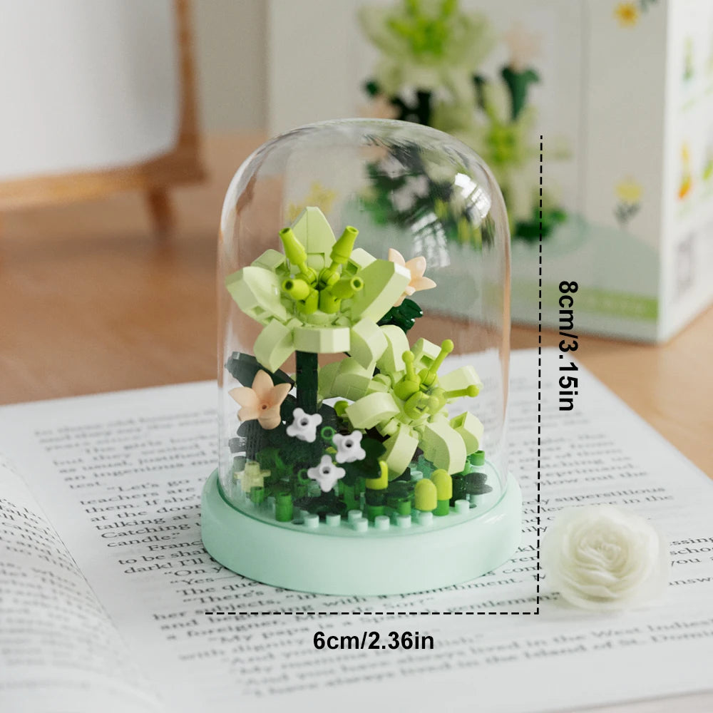 A clear glass jar filled with green and pink flower building blocks on a white surface.