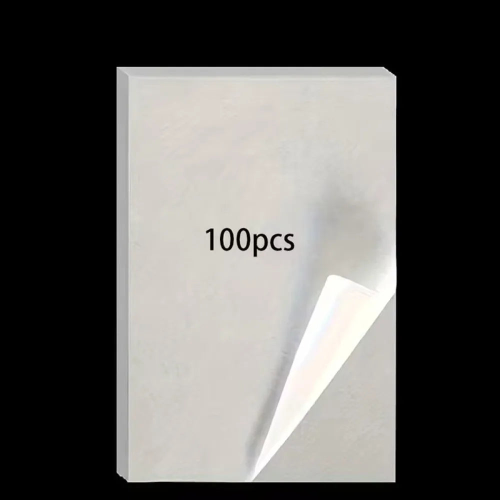A white sheet of double-sided diamond painting release paper with the text 100pcs printed on it.