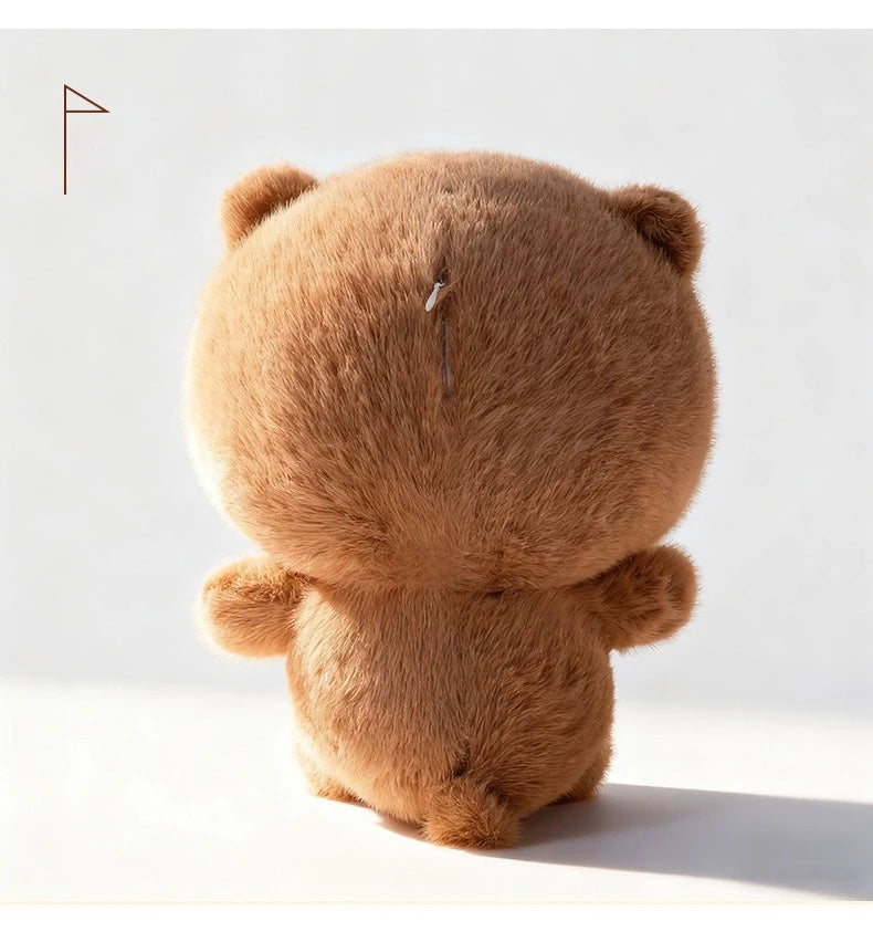 A fluffy brown panda plush toy viewed from the back, with a small pin visible on its head.