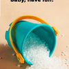 A turquoise bucket filled with thick, white, granular material, likely a sensory play item for children.