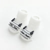 A pair of white cotton socks with gray cartoon animal prints for babies and toddlers.