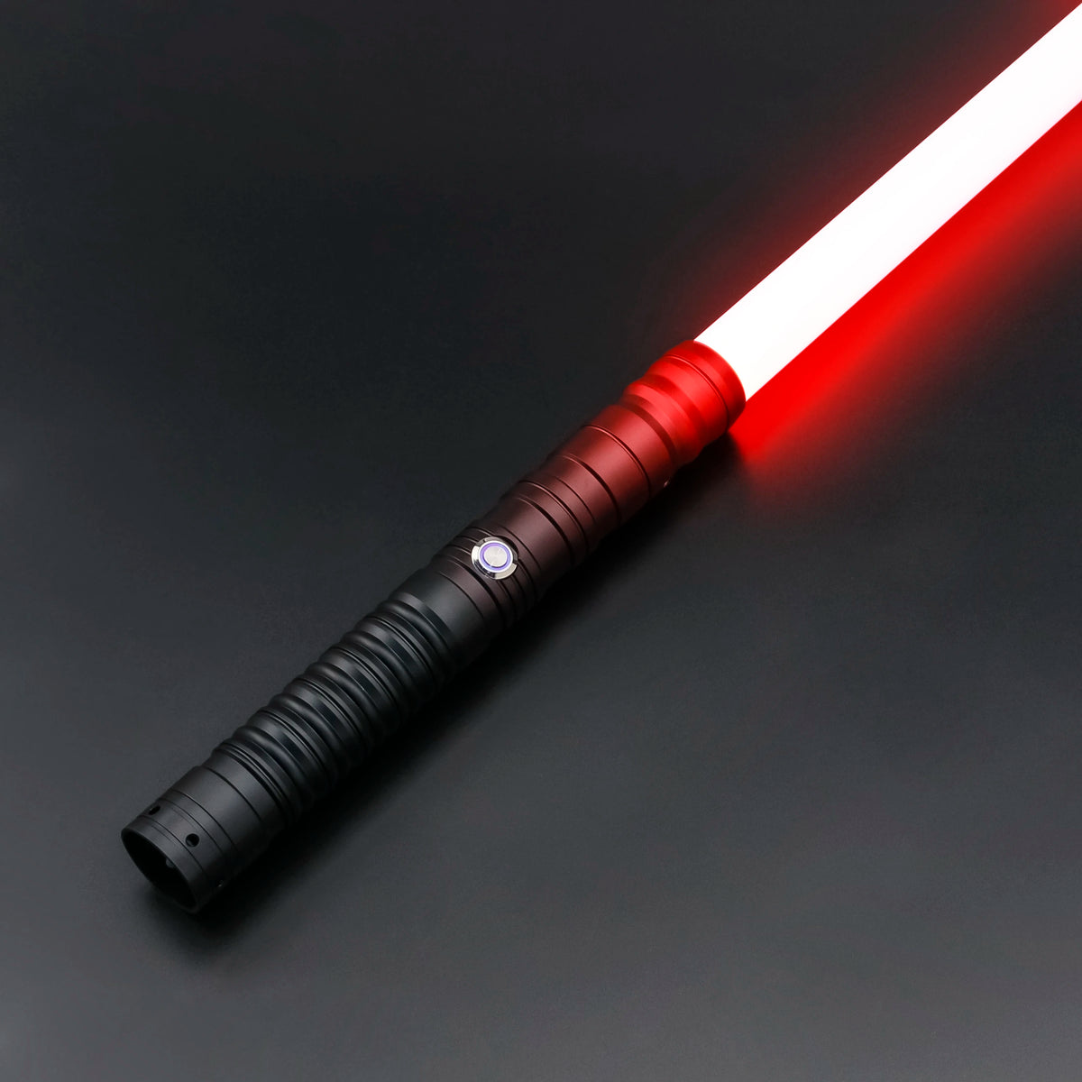 A white lightsaber toy with a red glow is shown diagonally on a dark surface.