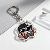 A clear acrylic keychain charm featuring an anime-style character with black hair and white markings, attached to a silver ke