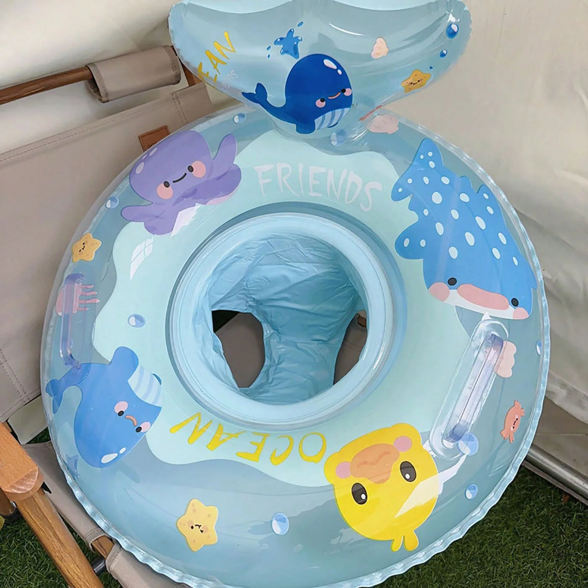 Light blue inflatable baby swim ring featuring sea creatures like a dolphin and a yellow chick.