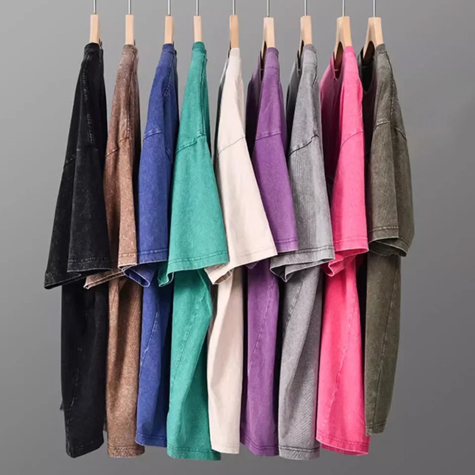 A display of various colored men's retro washed heavyweight cotton t-shirts hanging on hangers.