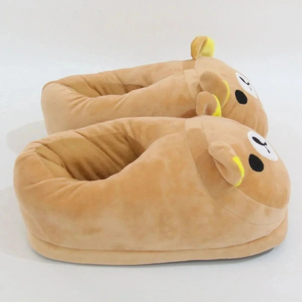 A pair of Kawaii Rilakkuma plush indoor slippers in brown with yellow accents.