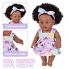 A realistic 12-inch African American baby doll with curly hair wearing a purple dress, demonstrating features like twisted ar