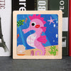 A wooden jigsaw puzzle featuring a pink unicorn-like creature with a spiky mane and various colorful elements on a blue backg