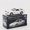 A white Mazda Savanna RX-7 die-cast model by Tomica in a box.