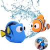 A blue rubber fish toy is shown splashing water, with another orange and white fish visible nearby.