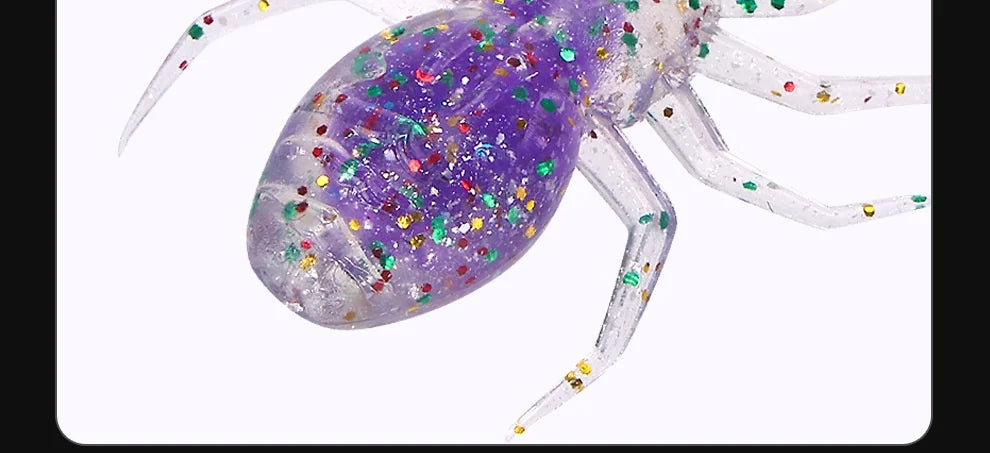 A purple, glittery, laser-reflective flexible fishing lure resembling a spider is shown.