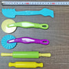 A set of air-dry modeling clay tools and molds in various colors including blue, green, and purple.
