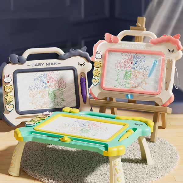 Three magnetic graffiti writing boards for kids in pink and green colors displayed on a wooden surface.