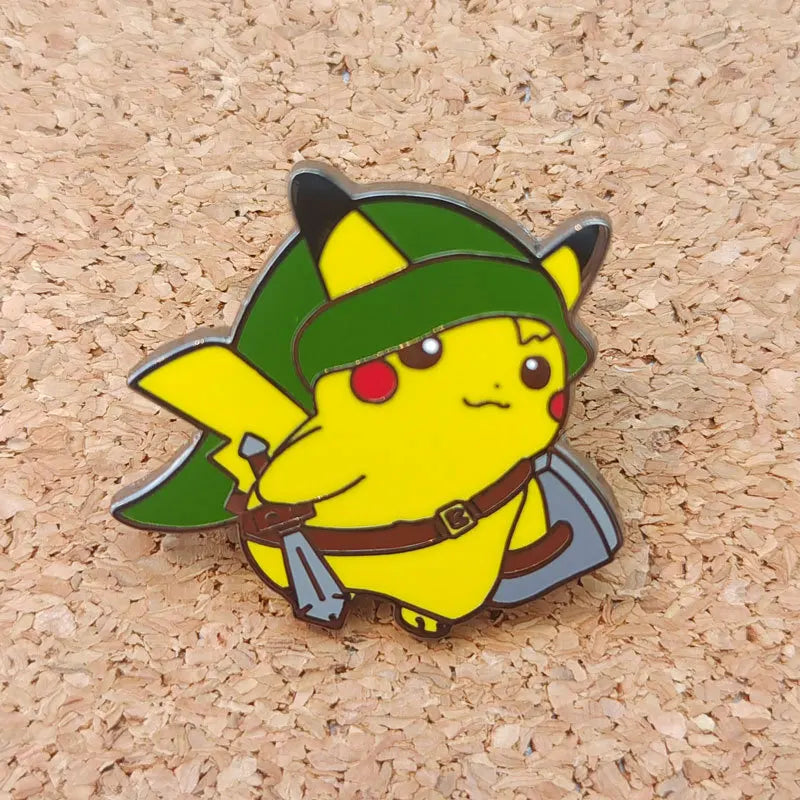 A yellow Pokémon enamel pin featuring a green hat and brown belt set against a light brown wooden background.