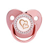 A rose gold crystal bling pacifier with a heart design for newborns.