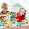 Two young children play with a set of colorful stacking blocks for a balance game.