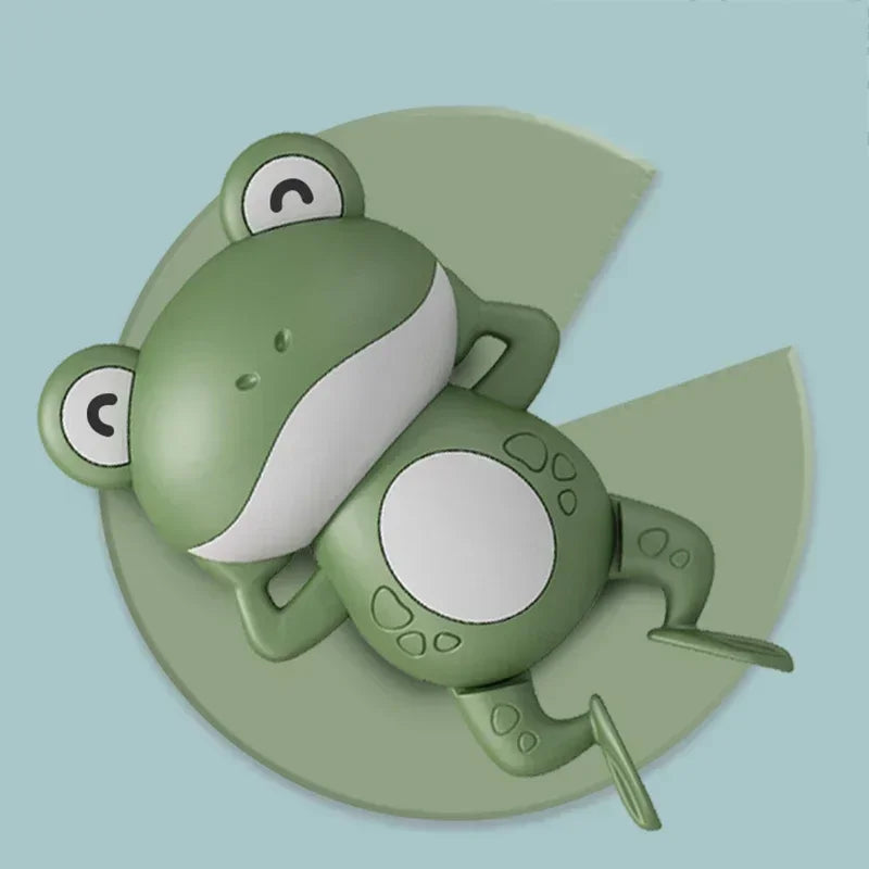 A green wind-up swimming duck bath toy for toddlers is shown resting on a light green surface.