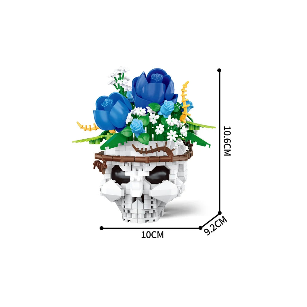 A set of white building blocks shaped like a skull, decorated with blue and white flowers and greenery.