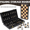 A folding storage board for chess pieces shown with an open wooden box displaying various chess pieces.