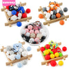 Assortment of colorful cartoon animal silicone beads for DIY jewelry making displayed on wooden trays.