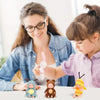 A woman is interacting with a child and several adorable animal-themed mini reborn baby dolls for pretend play.