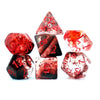 A set of red and clear crystal style polyhedral dice, including a triangular die and several other shapes.