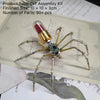 A steampunk metal spider DIY assembly kit with multiple legs and a glass bulb on a parchment background.