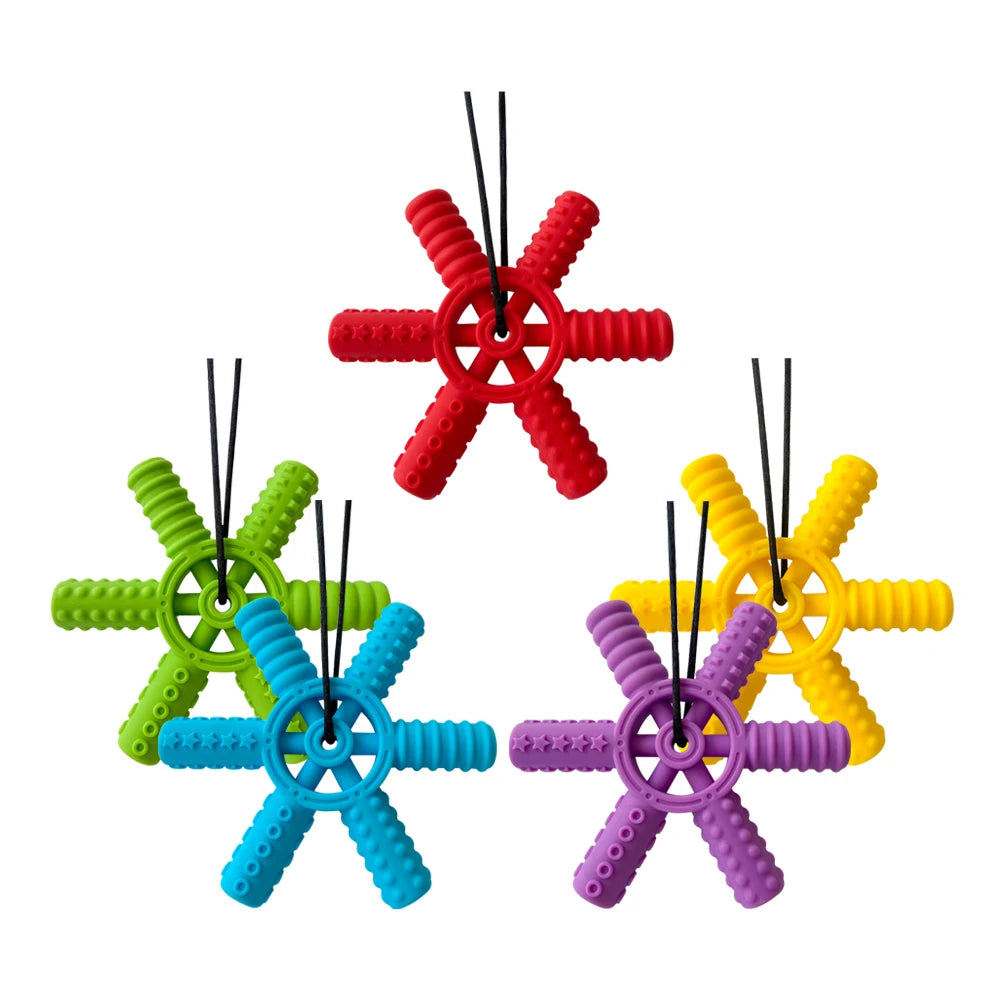 A set of silicone steering wheel teethers in red, green, blue, and purple for babies and toddlers.