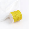 A roll of bright yellow 0.8mm cotton nylon macrame cord for jewelry making and crafts.