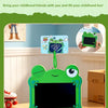 A green frog-shaped LCD drawing tablet keychain with an eraser and a screen is shown on a wooden table.