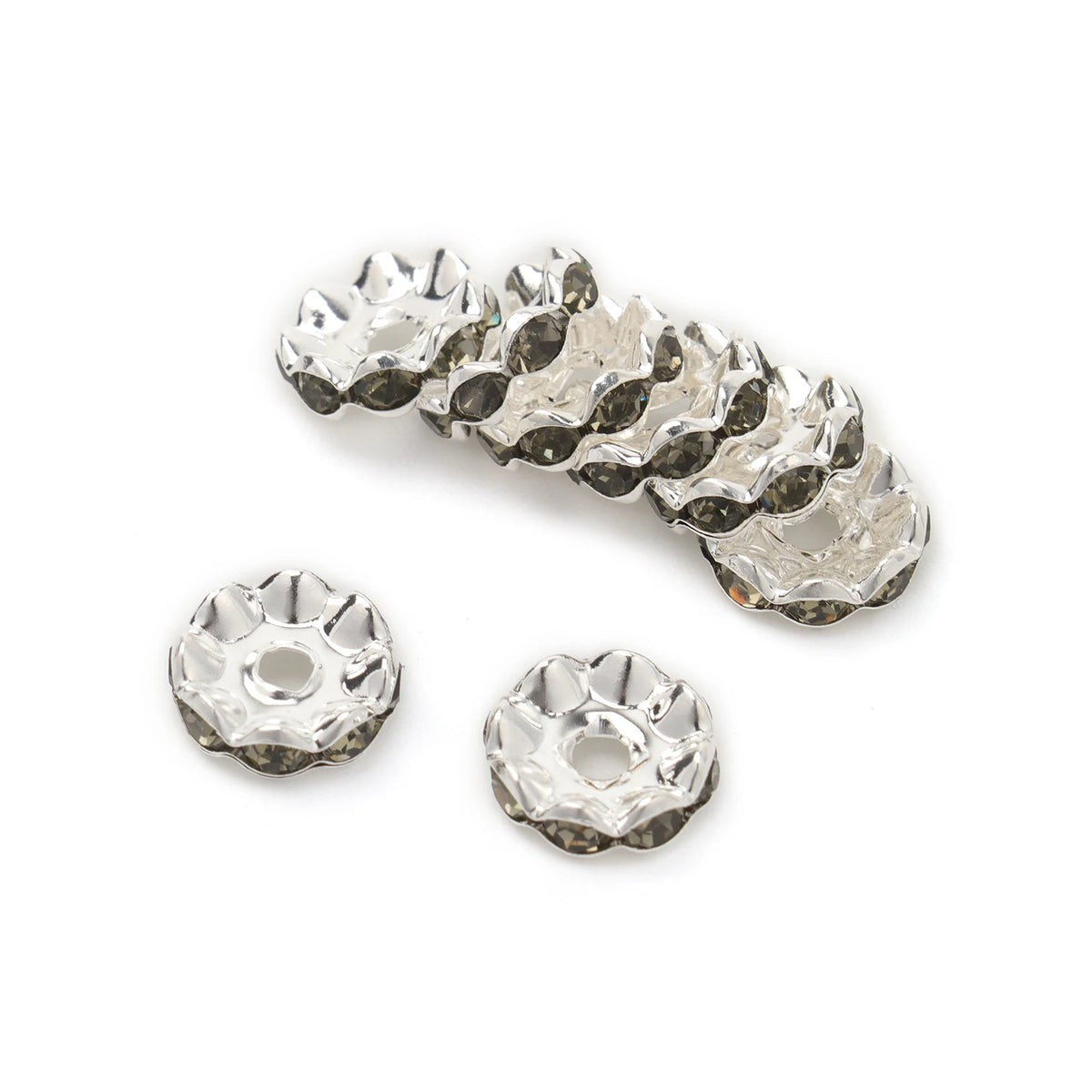 A collection of 12mm crystal rhinestone spacer beads for jewelry making, shown in various sizes and angles.