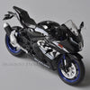 A glossy black Suzuki GSX-R1000R diecast motorcycle model in a dynamic pose.