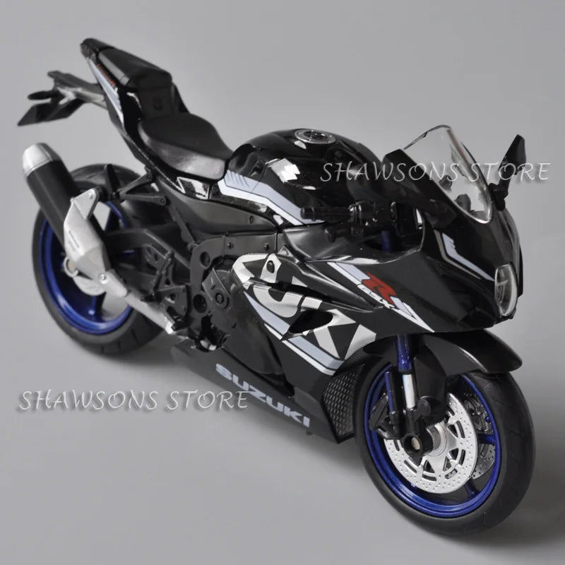A glossy black Suzuki GSX-R1000R diecast motorcycle model in a dynamic pose.