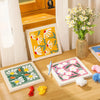 A box of flower pattern punch needle embroidery kits featuring various colored threads and needles.