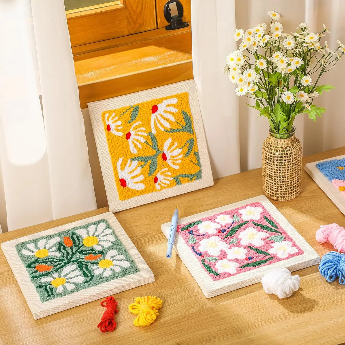 A box of flower pattern punch needle embroidery kits featuring various colored threads and needles.