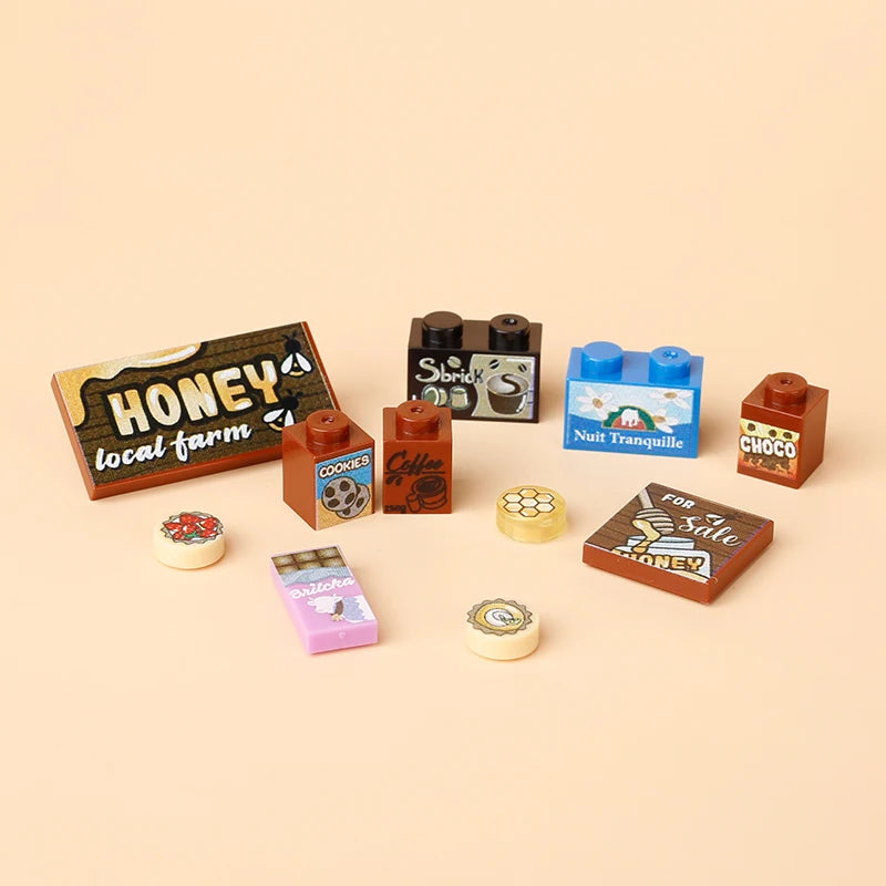 A collection of wooden building blocks shaped like various foods and items including honey, cookies, and cheese.