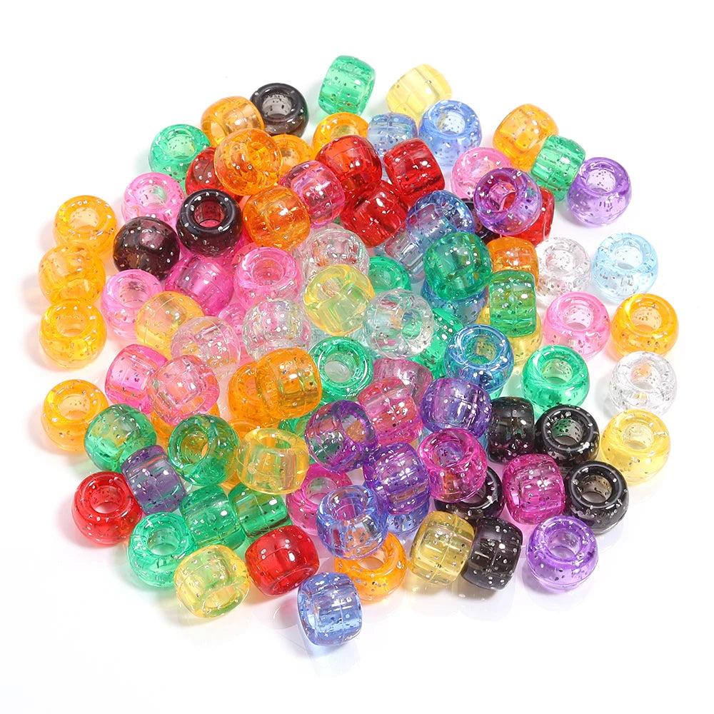 A pile of 200 colorful pony beads in various shades including orange, pink, green, and purple.